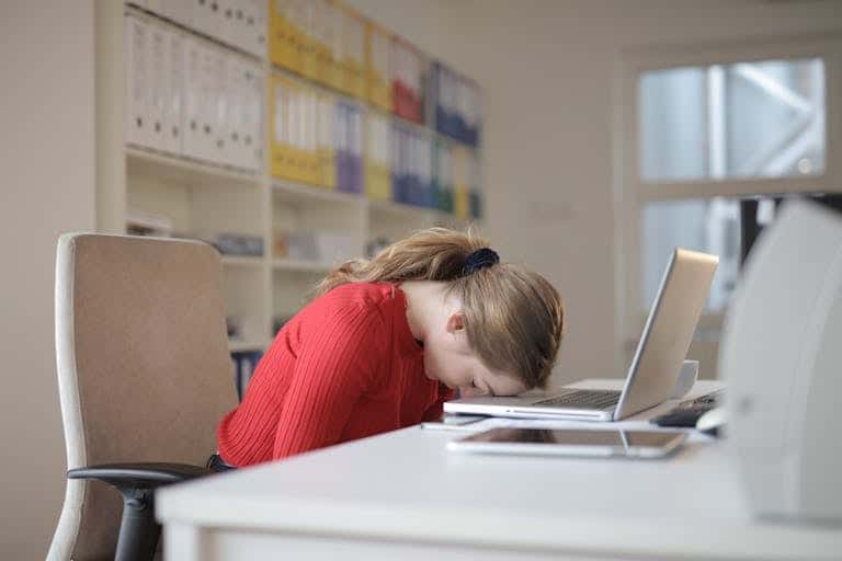 Boss Sitting on Chair after learning more people have quit their job While Leaning on Laptop