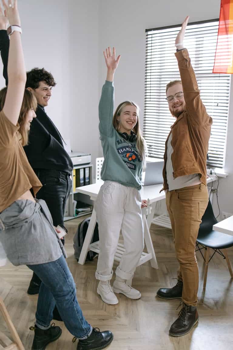 Man in Black T-shirt celebrating with friends after a great first impression after his interview