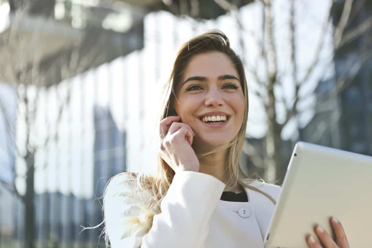 Woman In White Blazer Holding Tablet Computer for the contact me